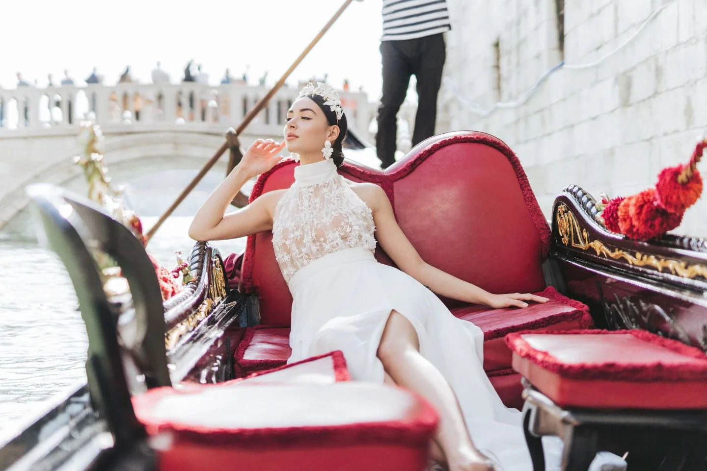 Bride in Rime Arodaky Couture, riding a gondola on Venice's canals during her luxury destination wedding in Italy